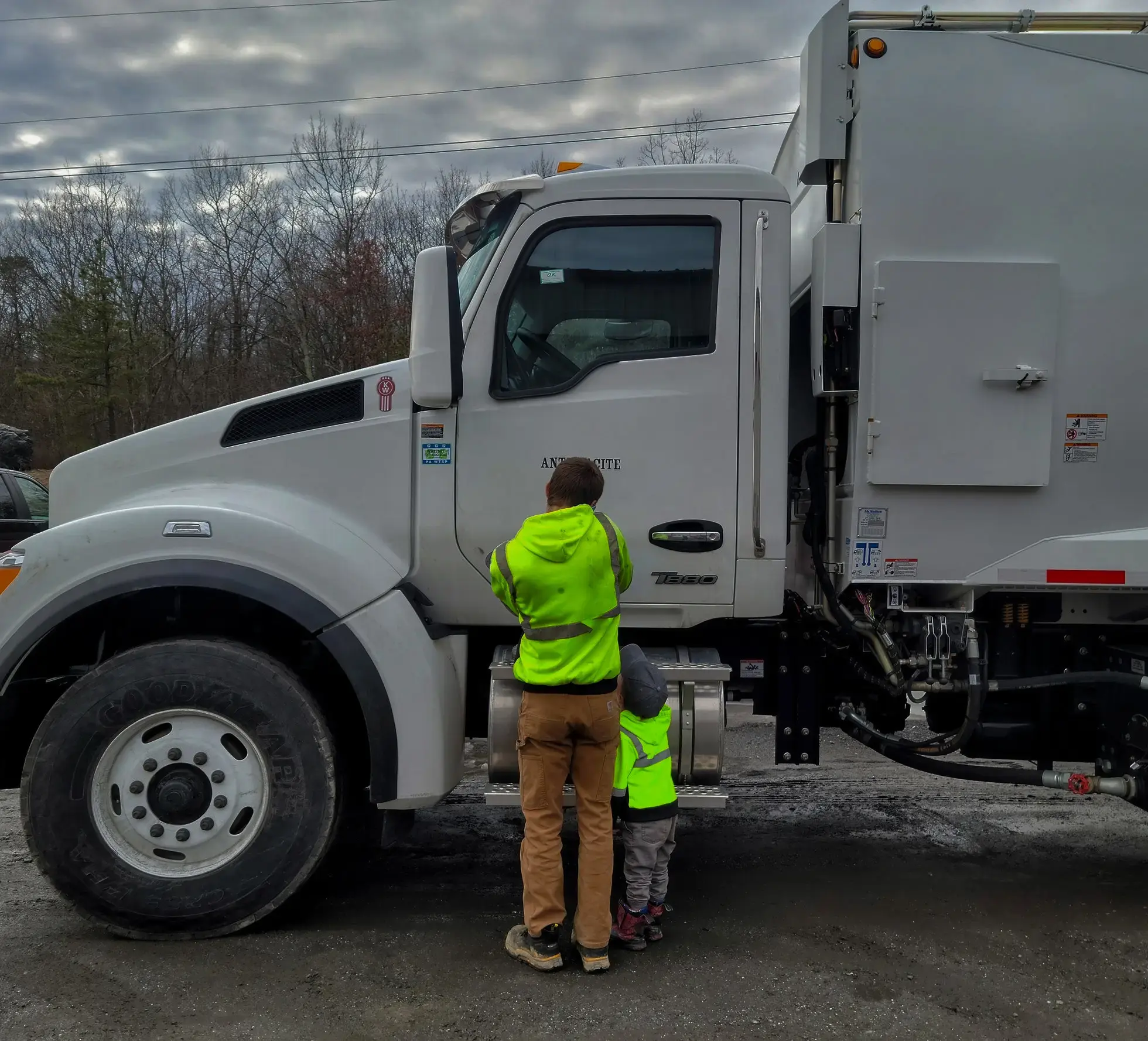 family at trash truck